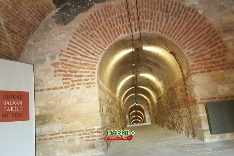 Illuminated interior corridor of Hıdırlık Tabyası (Hıdırlık Fort) in Edirne showing the historic underground passageway