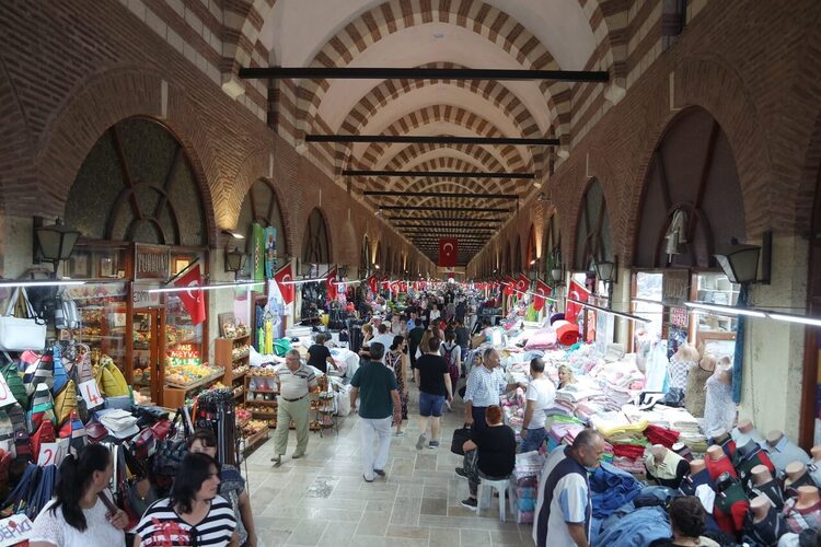 *Inside Ali Paşa Covered Bazaar in Edirne, with shops on both sides and customers browsing*