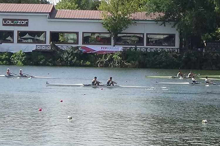 Rowing crews passing a riverside facility on the Meriç River in Edirne