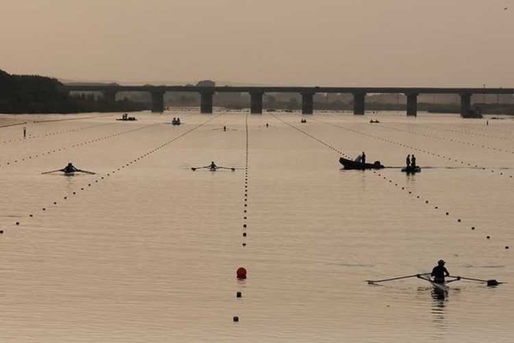 Rowing crews in lanes on the Meriç River in Edirne with Mecidiye Bridge in the background