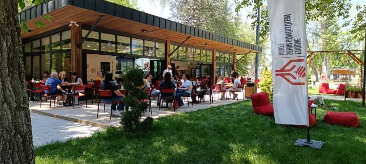 People sitting at an open-air café in Edirne Millet Bahçesi riverside park