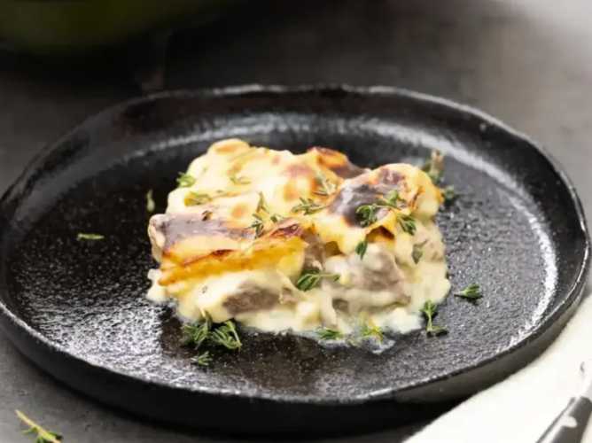 Elbasan tava prepared with lamb cooked in a yogurt-based sauce, a traditional dish from Ottoman and Balkan cuisine.