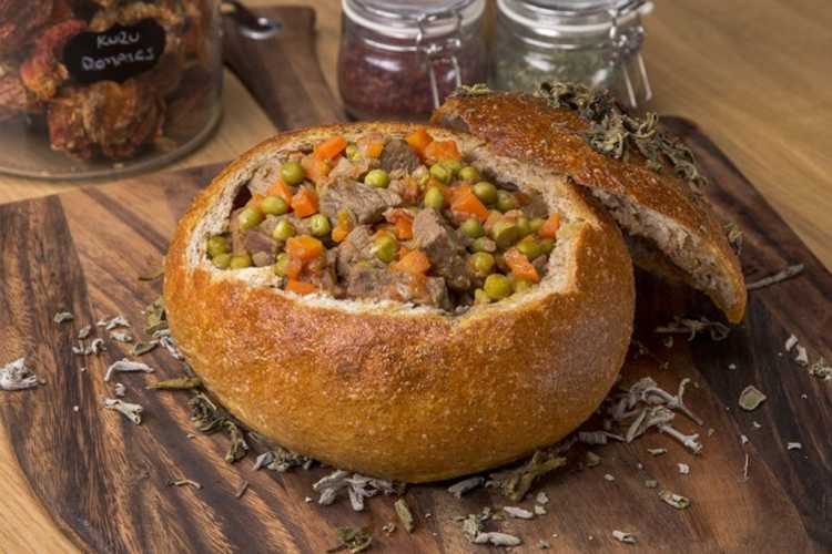 Fodula dish prepared with beef and vegetables placed inside hollowed rye bread, a traditional Ottoman palace cuisine recipe.