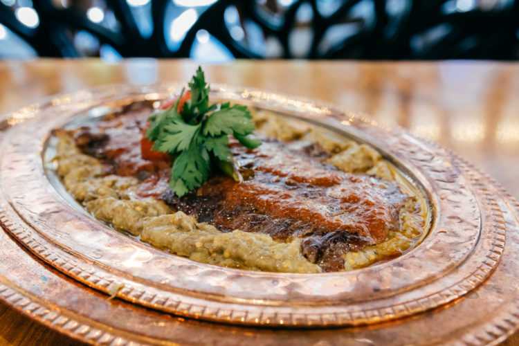Traditional Hünkar Beğendi Ottoman dish featuring lamb stew placed over creamy eggplant purée.
