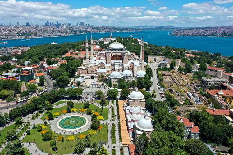 Aerial view of Hagia Sophia Mosque in Istanbul, Turkey, with the Bosphorus and city skyline in the background.