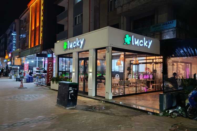 Exterior of Lucky Café bar on Bahriye Üçok Street, Edirne, showing students and evening activity