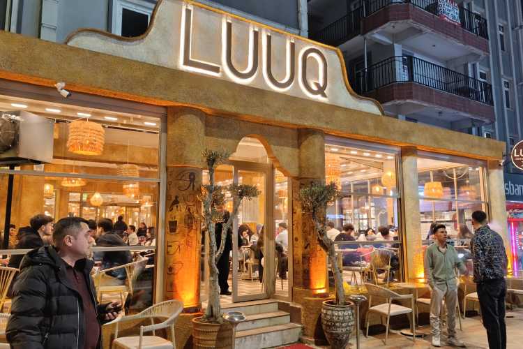 Exterior of Luuq Coffee on Bahriye Üçok Street, Edirne, showing young people socializing outside the café in the evening
