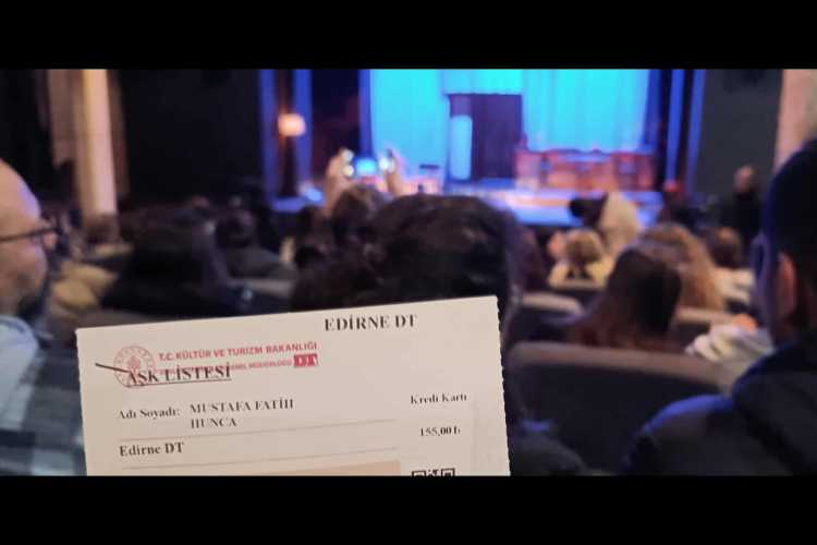 Back rows of audience in dark hall with a theatre ticket, watching a play at Edirne Atatürk Cultural Center