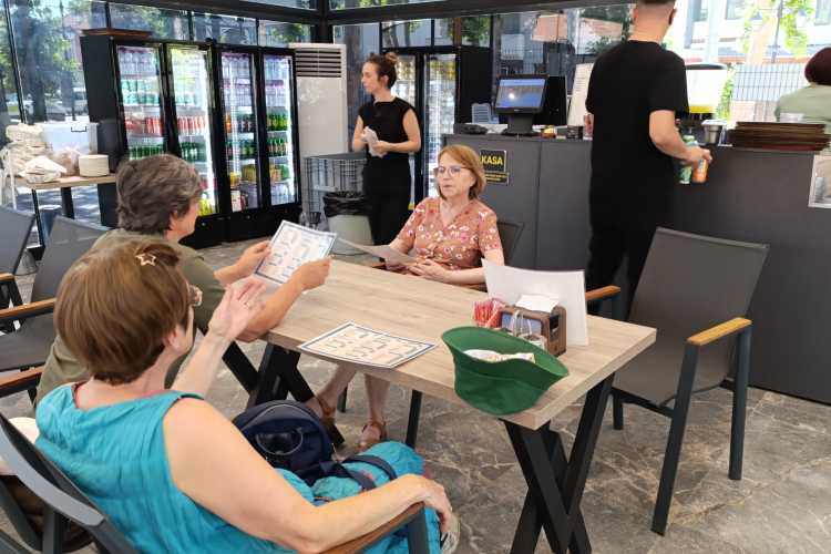 Friends sharing snacks and drinks after visiting art venues in Edirne