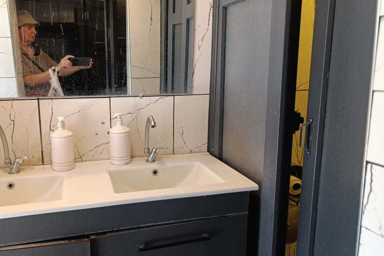 Interior of a municipal public toilet in Edirne, Turkey, showing a mirror and wash basin