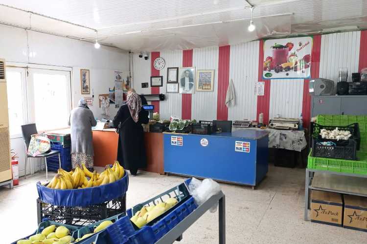 Two women paying at the checkout of a local market stall in Edirne, Turkey.